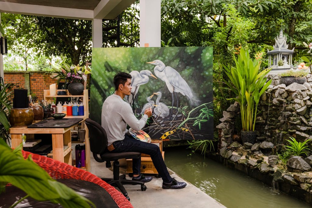 Artist Channy Chhoeun working outdoors at his home art studio